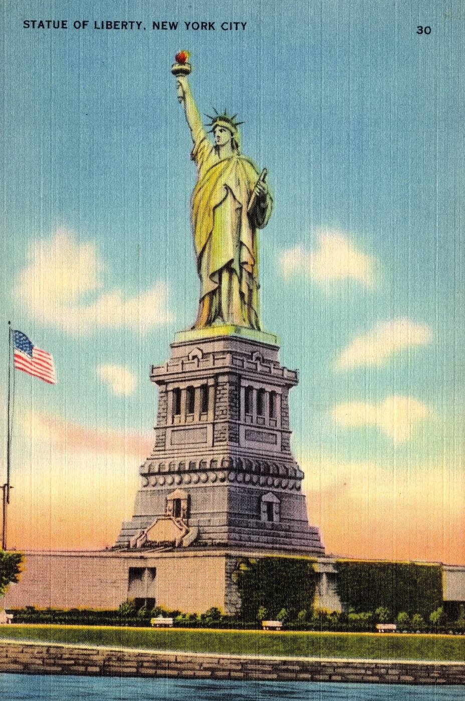 Linen postcard of the Statue of Liberty in New York City with an American flag at left